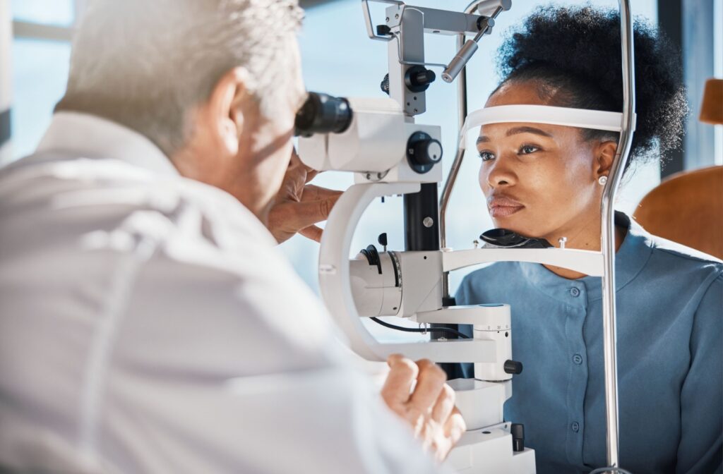 An optometrist examines their patient's eyes and asses their eye health during a regular eye exam.