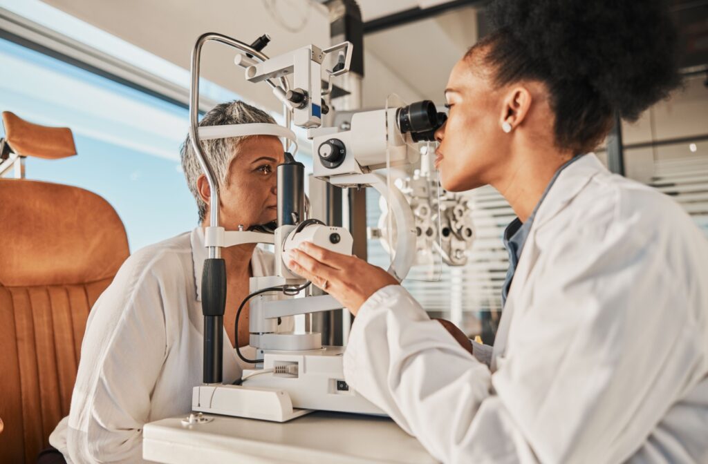 An optometrist evaluates a patient's eye with a slit lamp.