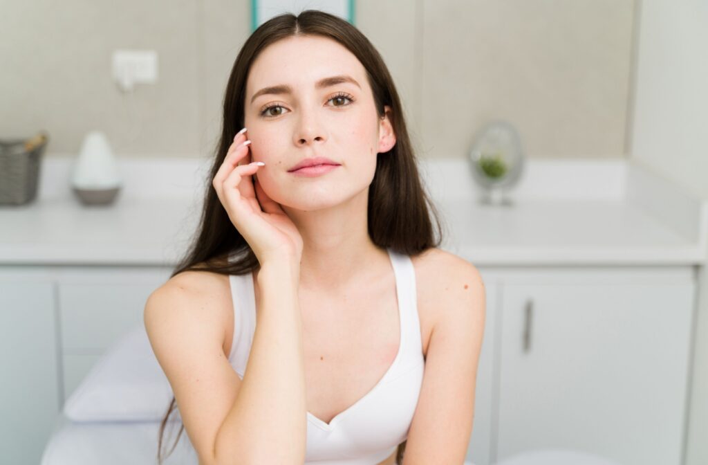 A person looking at their skin in the mirror