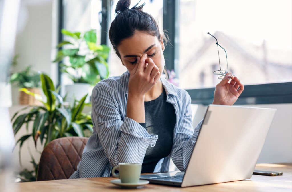 A person rubbing in between their eyes as they have a headache